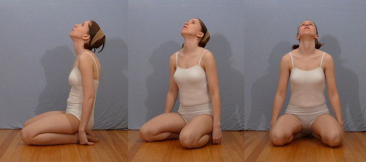 a woman is sitting on the floor and doing yoga