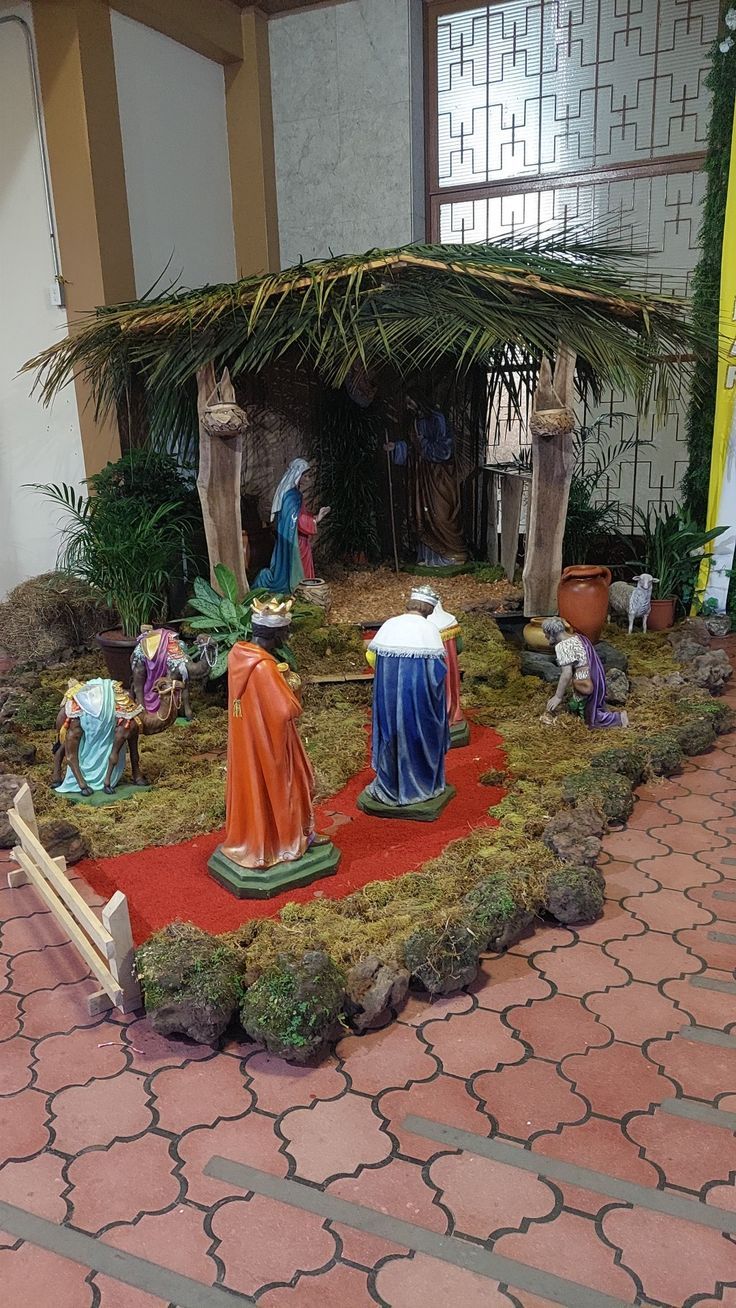 an outdoor nativity scene with figurines and decorations