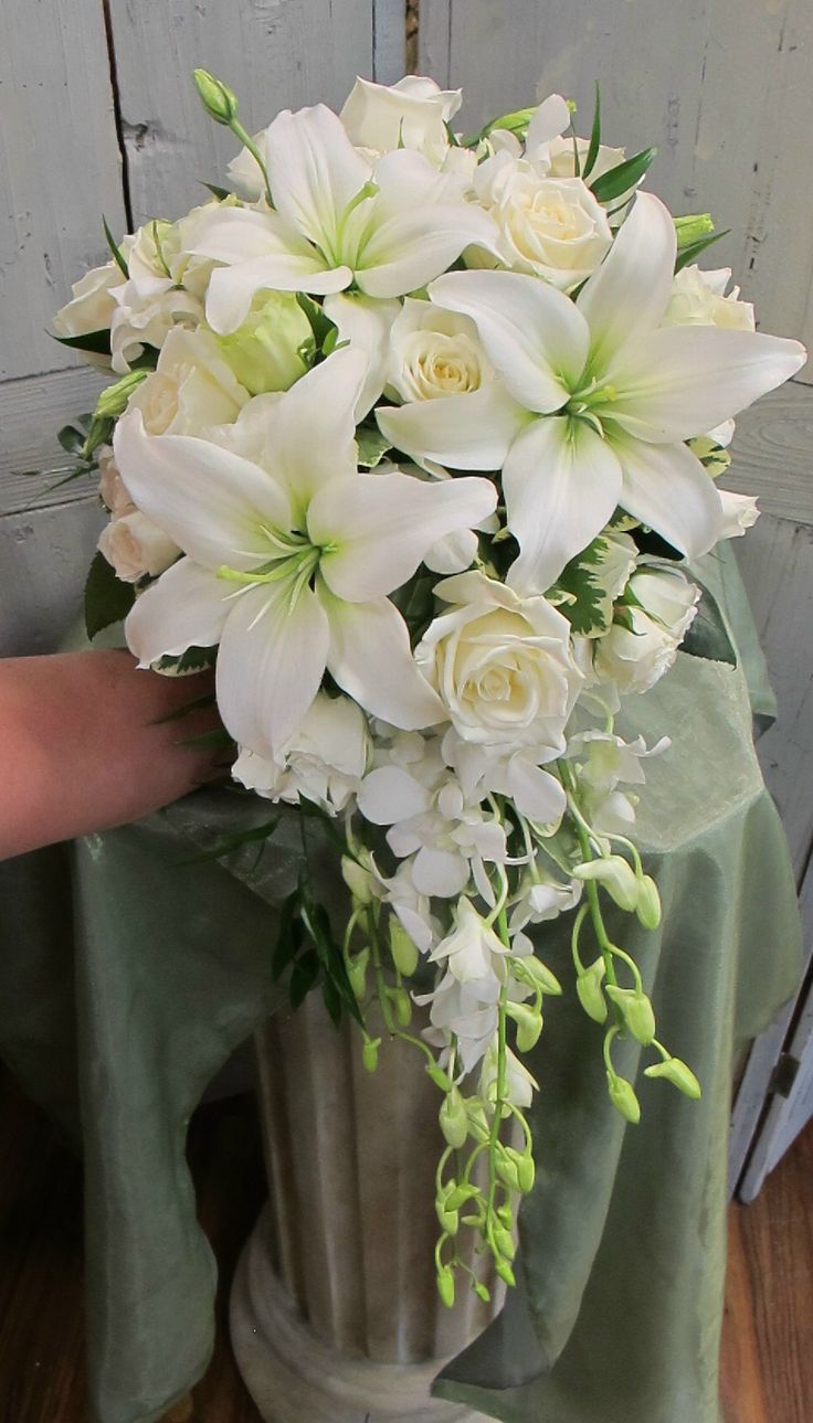 a bouquet of white flowers sitting on top of a table