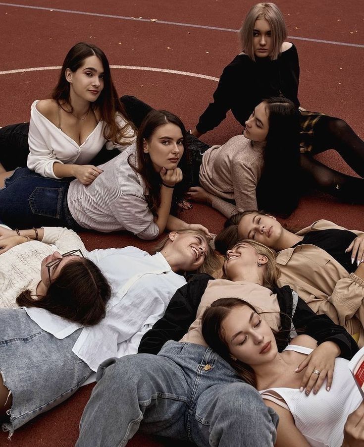 several women are laying on the ground together