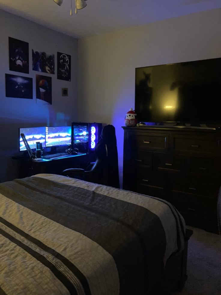 a bed room with a neatly made bed and a flat screen tv on the wall