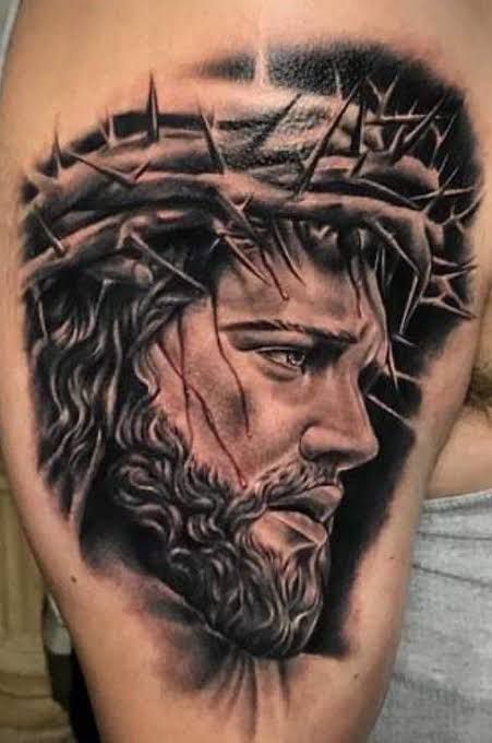 a man with a crown on his head is shown in black and grey tattoo art