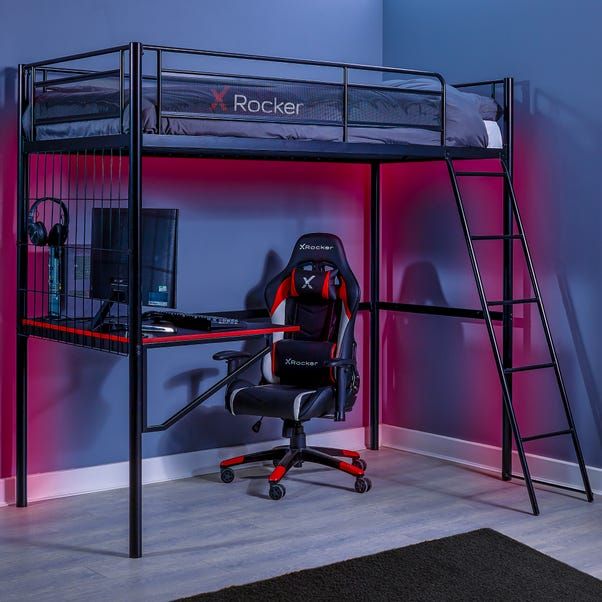 a loft bed with a desk and chair in front of it, next to a purple wall