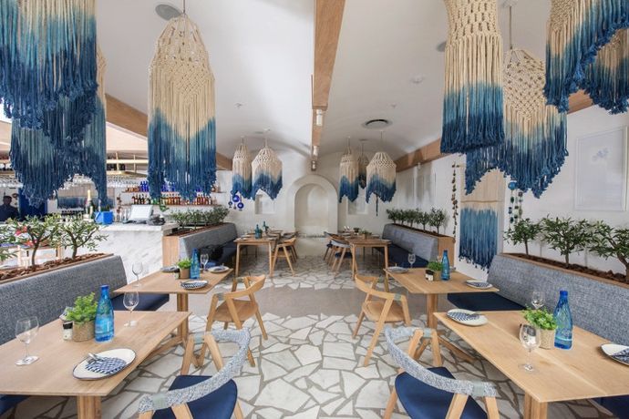 the inside of a restaurant with blue and white decor