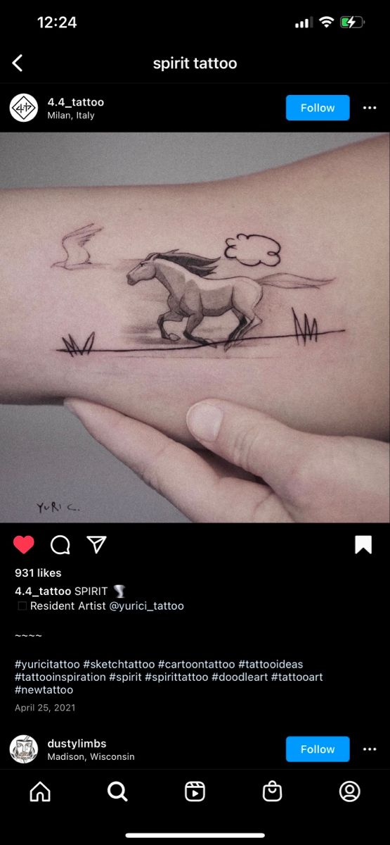 someone is holding their arm with a horse tattoo on it