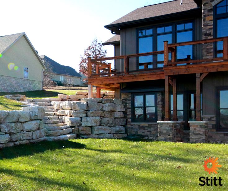 a large stone wall in front of a house