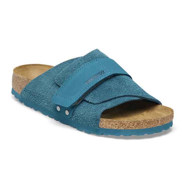 The Kyoto slide maximizes your comfort with its minimalist-friendly design. A nubuck hook-and-loop strap creates the perfect fit over velvety soft suede. It's all grounded in our contoured footbed designed to shape to you with wear for the ultimate in support. Contoured cork-latex footbed creates custom support with wear Classic suede upper Suede footbed lining helps keep you comfortable EVA sole is flexible and lightweight Nubuck leather hook-and-loop strap Made in Germany Blue Suede Sandals With Leather Footbed, Blue Leather Slides With Textured Footbed, Blue Leather Slides With Leather Footbed, Comfortable Adjustable Suede Slides, Adjustable Suede Slides With Removable Insole, Birkenstock Kyoto, Birkenstock Styles, Deep Turquoise, Friendly Design