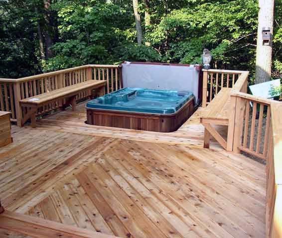 a hot tub sitting on top of a wooden deck