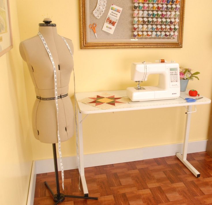 a sewing machine sitting on top of a table next to a dressmaker's mannequin