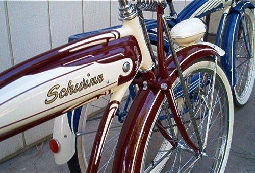 two red and white bicycles parked next to each other