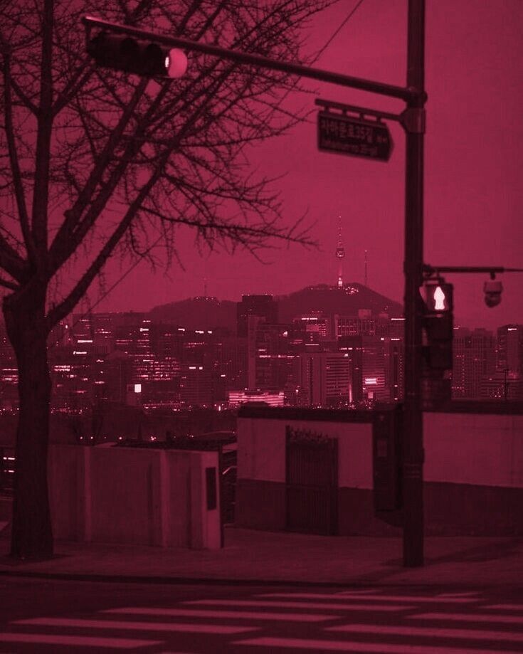 a red toned photo of a city at night