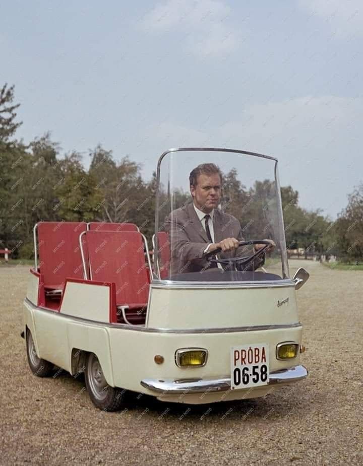 a man driving a car with two seats in the back