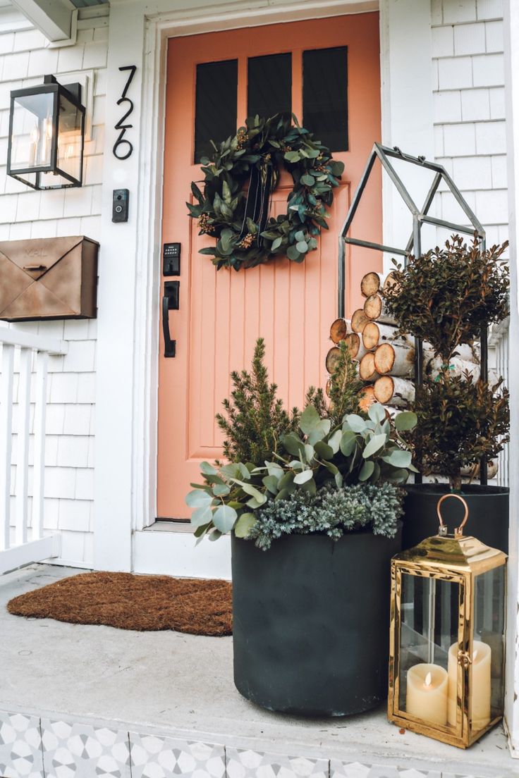 the front door is decorated with wreaths and candles