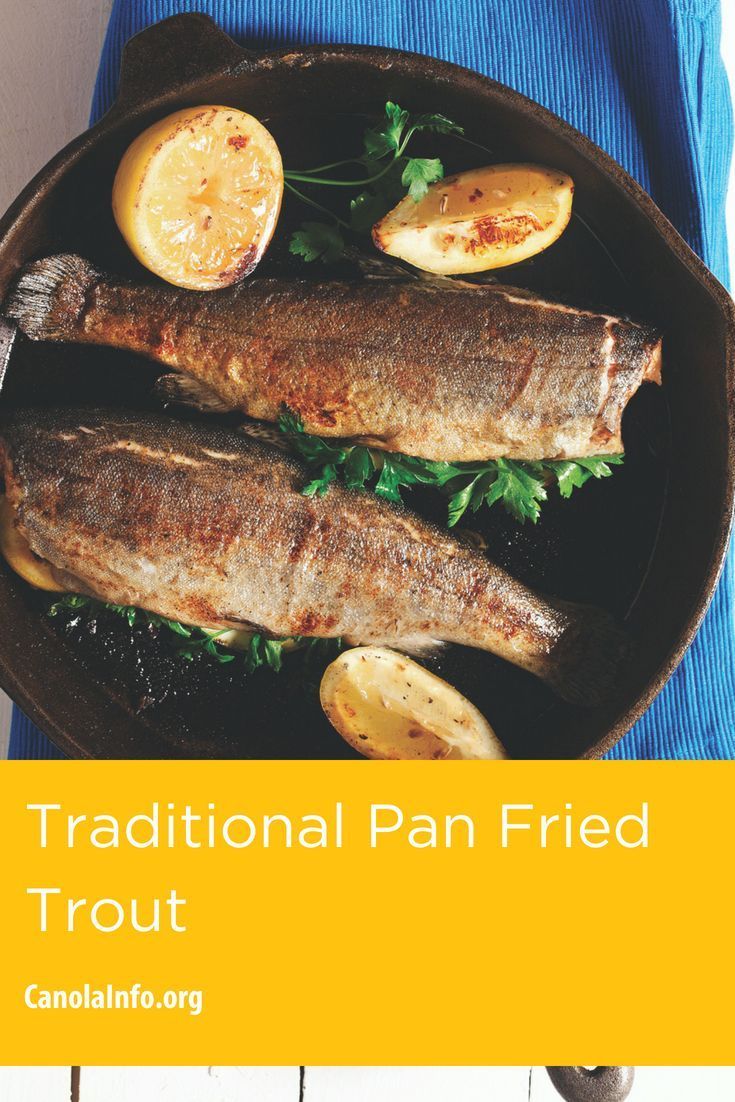 two fish on a plate with lemons and parsley next to it, the title reads traditional pan fried trout