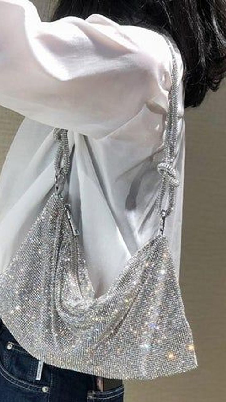 A woman accessorizing with a silver rhinestone crossbody bag, featuring sparkly diamante detailing. This glamorous evening handbag is perfect for parties, bridal events, or a night out on the town. Sparkly Purse, Silver Clutch Bag, Bag Outfit, Silver Clutch, Wedding Purse, Metallic Purse, Rhinestone Cross, Evening Handbag, Silver Colour