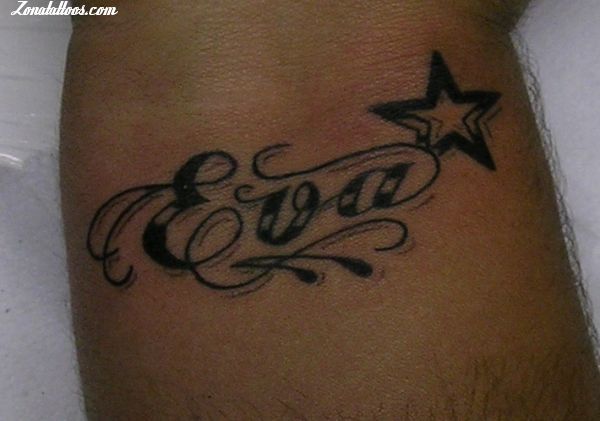 a man with a tattoo on his arm has the word god written in cursive writing