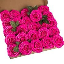 a box filled with pink roses sitting on top of a table