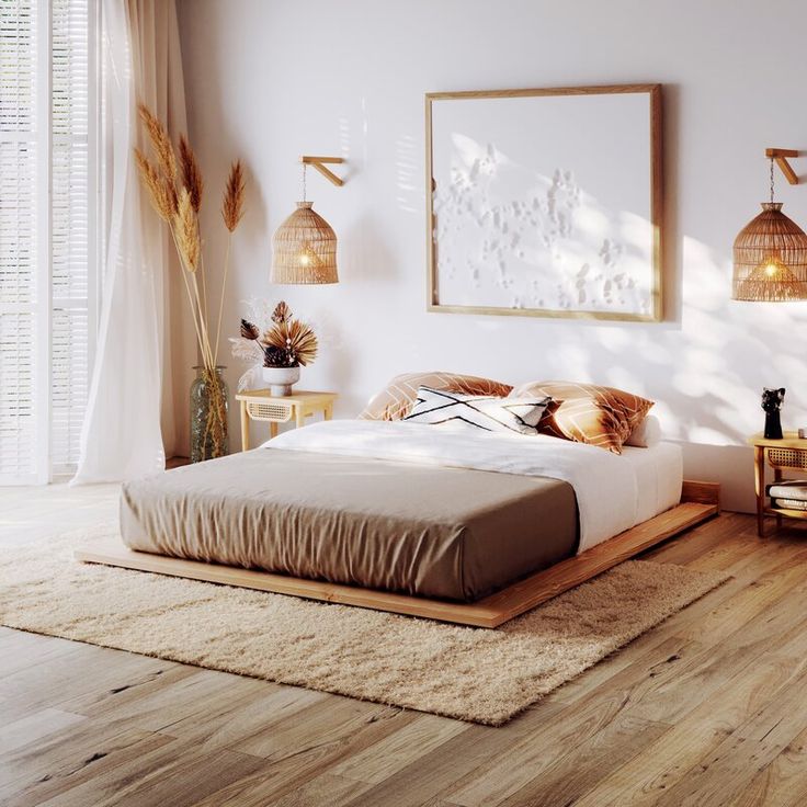 a bedroom with white walls and wooden floors, an art work on the wall above the bed