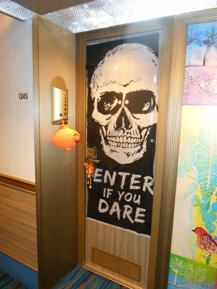 an open door with a sign that says enter if you dare on it and a skull in the center