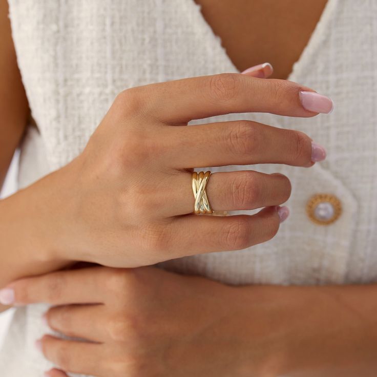 a woman's hand wearing a gold ring