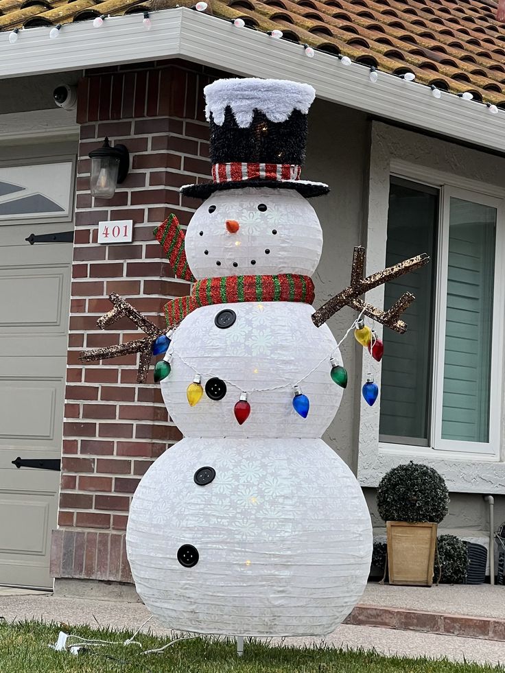 a snowman made out of paper on the lawn