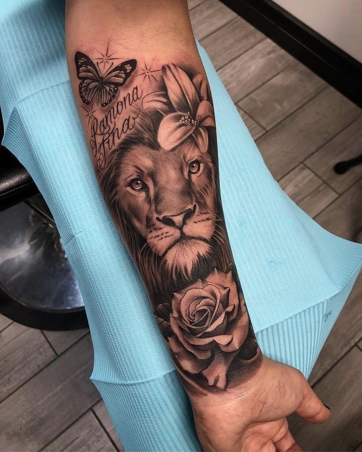 a woman with a lion and roses tattoo on her arm