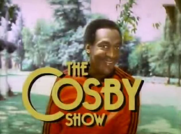 the cosby show logo with an image of a smiling man in a red jacket