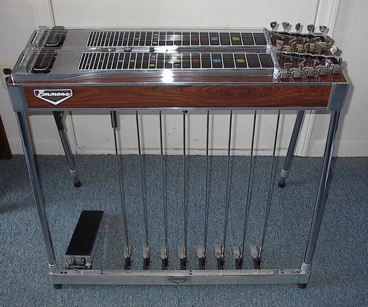 an electronic device sitting on top of a wooden table next to a metal rack filled with keys