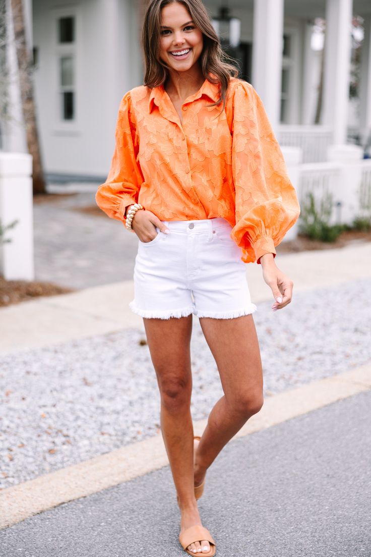 This timeless orange blouse is anything but ordinary. With a unique textured floral print and classic fit, you can truly stand out from the crowd. Long bubble sleeves give it an extra touch of sophistication. Elevate your wardrobe with a blouse that has all the details. This blouse features built in tank lining, long bubble sleeves, a collared neckline, button down front closure, and a textured floral print. Material has no amount of stretch.Sydney is wearing the small. Chic Orange Cotton Blouse, Orange Long Sleeve Blouse For Spring, Chic Orange Blouse For Spring, Orange Floral Print Shirt For Spring, Orange Cotton Blouse For Work, Orange Cotton Blouse For Day Out, Orange Long Sleeve Blouse For Day Out, Long Sleeve Orange Blouse For Day Out, Chic Orange Shirt For Spring