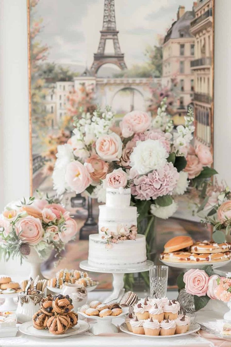 a table topped with lots of desserts and flowers