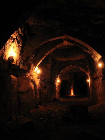 an old tunnel with lights in the dark