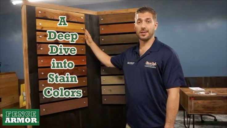 a man standing next to a sign that says deep dive into stain colors