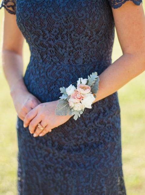 a close up of a person wearing a dress and holding a flower in their hand