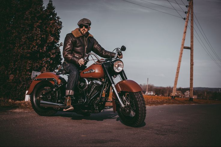 a man sitting on the back of a motorcycle