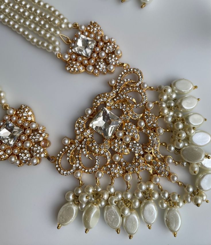 an assortment of pearls and gold jewelry