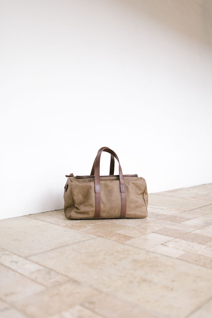 Nisolo Waxed Canvas Weekender Bag Functional Brown Duffle Bag For On-the-go, Modern Gym Bag With Luggage Sleeve For Weekend Trips, Everyday Canvas Travel Bag With Top Handle, Everyday Canvas Travel Bag With Top Carry Handle, Canvas Travel Bag With Top Carry Handle, Rectangular Waxed Canvas Bag With Luggage Sleeve, Practical Leather-handled Bag For Travel, Modern Weekender Bag With Top Carry Handle For Trips, Rectangular Waxed Canvas Travel Bag