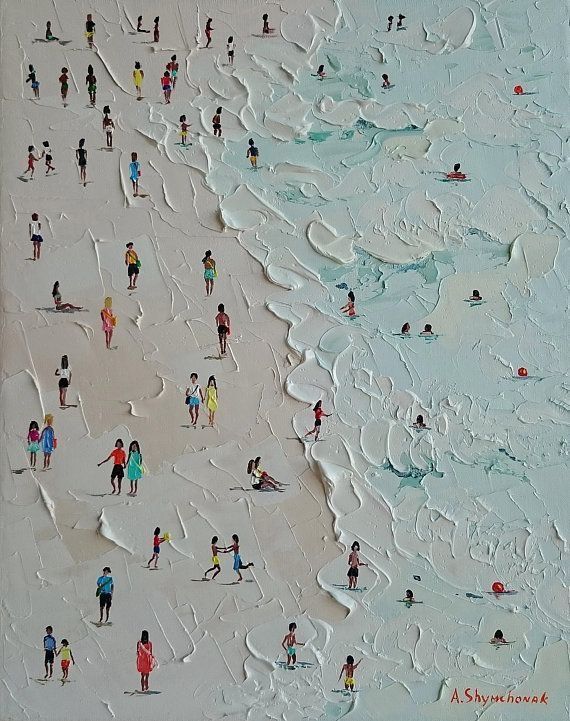 a group of people standing on top of a beach covered in white sand next to the ocean