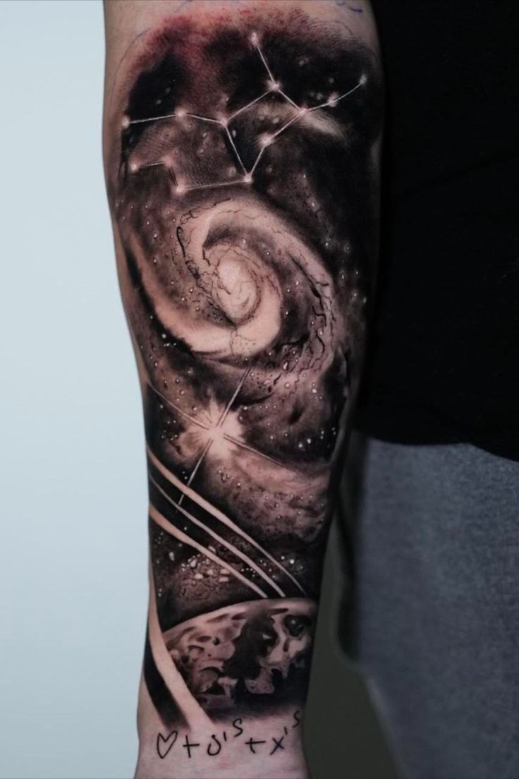 a man with a tattoo on his arm that has an image of the earth and stars