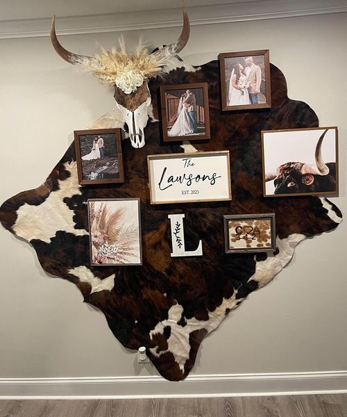 a cow's head with pictures on it is mounted to the wall