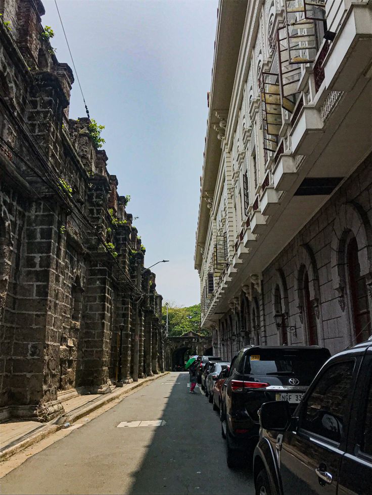 cars are parked on the side of an old street