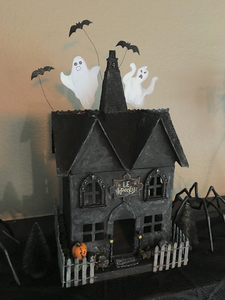 a house decorated for halloween with ghost decorations