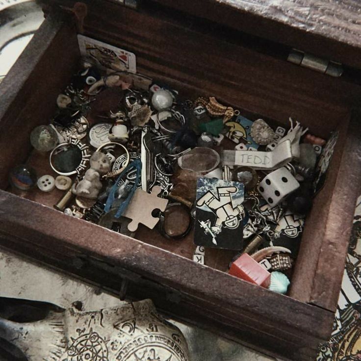 a wooden box filled with lots of different types of buttons and jewelry on top of a table