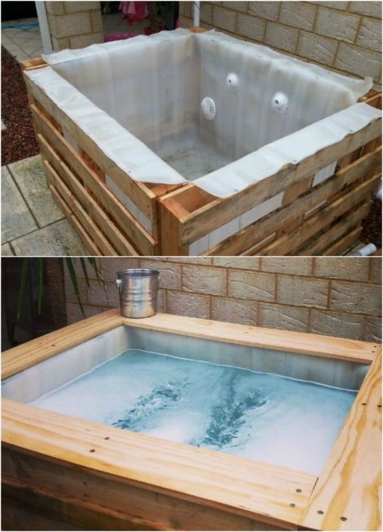 an outdoor hot tub made out of pallets and wooden crates with water in it