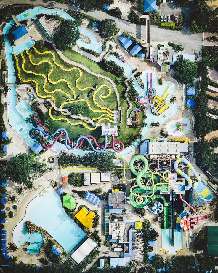 an aerial view of a park with many rides