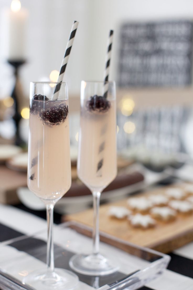 two glasses filled with champagne sitting on top of a table