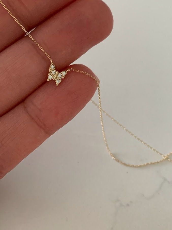 "14K Yellow Gold Gold Butterfly Necklace 16\"+2, Dainty Butterfly Chain, Minimalist Necklace, Layering Necklace, Butterfly Chain, Butterfly ♦ Materials: 14K Yellow Gold, Cubic Zirconia ♦ Available colors: Yellow Gold ♦ Necklace measurements: 16\" with a 2\" extender, for a total length of 18\". The chain is 1MM wide. The charm is 5MM -------------------------------------------------- ♦ -------------------------------------------------- MATERIALS All chains and pendants are made of 14K Solid Gold M Necklaces, Minimalist Jewelry Aesthetic, 14k Gold Butterfly Necklace, Dainty Butterfly Necklace, Gold Dainty Necklace, Gold Butterfly Necklace, Necklace Measurements, Gold Minimalist Jewelry, Butterfly Chain