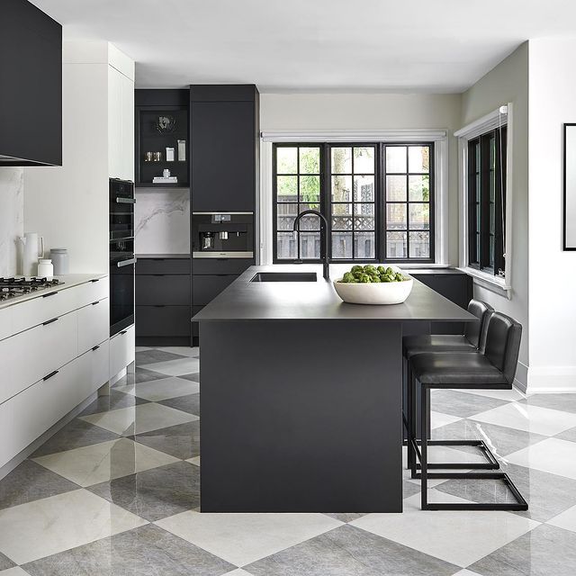 a modern kitchen with black and white checkered flooring