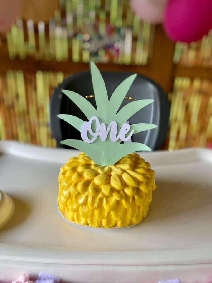 a pineapple shaped cake sitting on top of a white plate