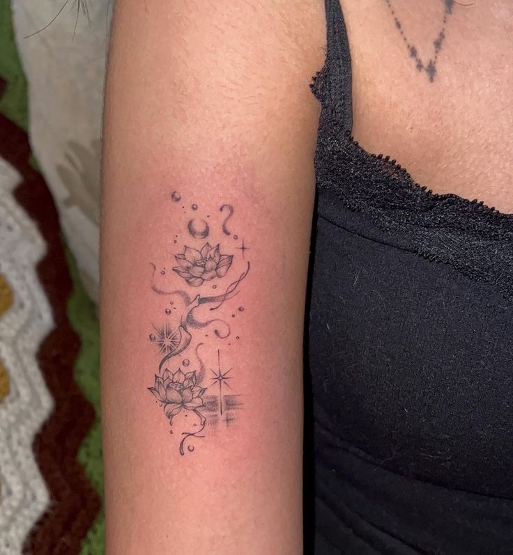 a woman's arm with a flower tattoo on the left side of her arm