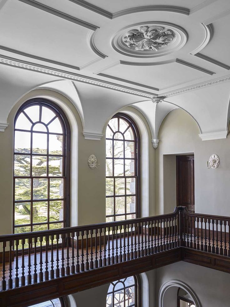 the interior of an old building with arched windows and wrought iron balconies on the second floor